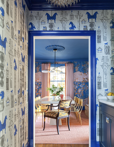 A dining room with blue and white wallpaper